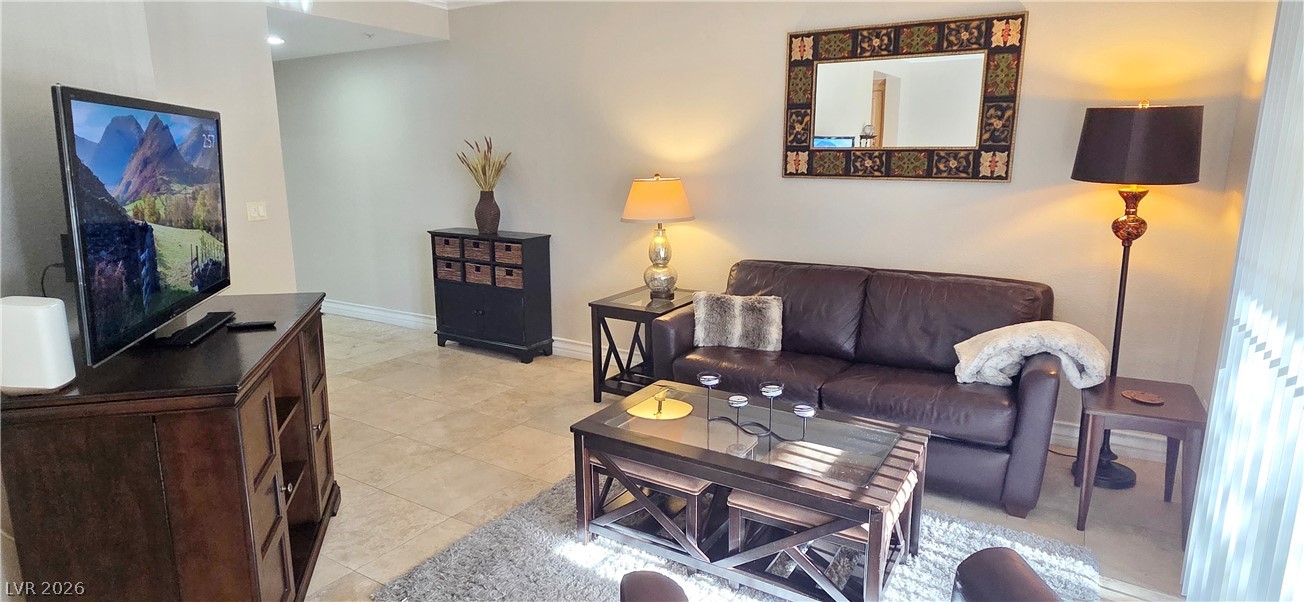210 East Flamingo Road, Unit 208 Las Vegas, NV 89169 - Photo 8 of 42 The living area offers durable tile flooring, providing a relaxed atmosphere for daily living.