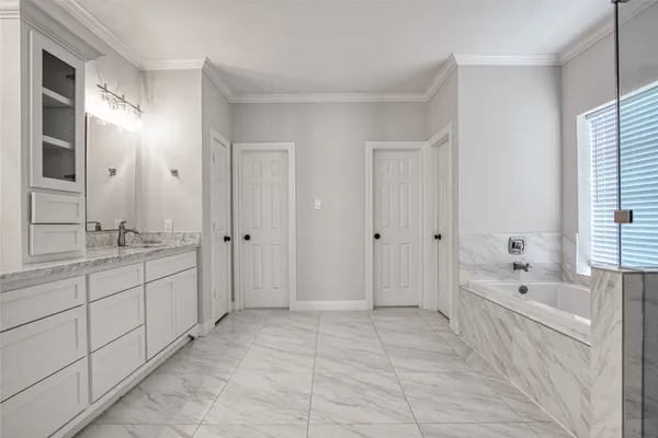 a spacious bathroom with a mirror a shower and a bathtub