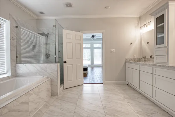 a spacious bathroom with a tub shower and sink