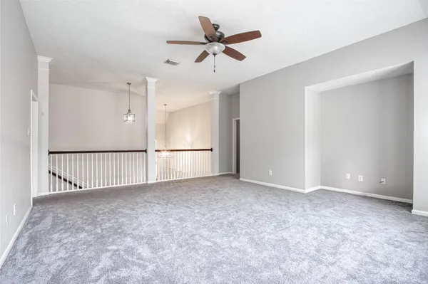 an empty room with a ceiling fan and a ceiling fan