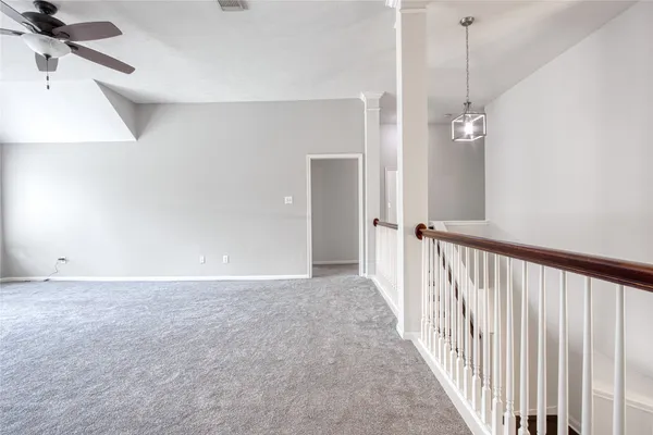 a view of a room with a ceiling fan