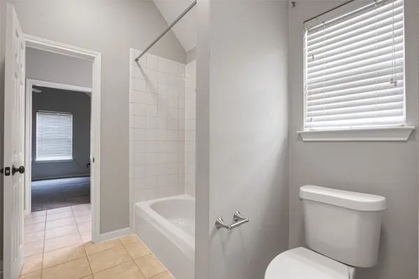 a bathroom with a toilet and a bathtub