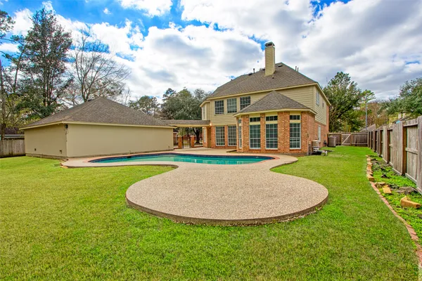 a view of a house with a swimming pool and yard