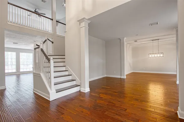 a view of entryway and hall with wooden floor