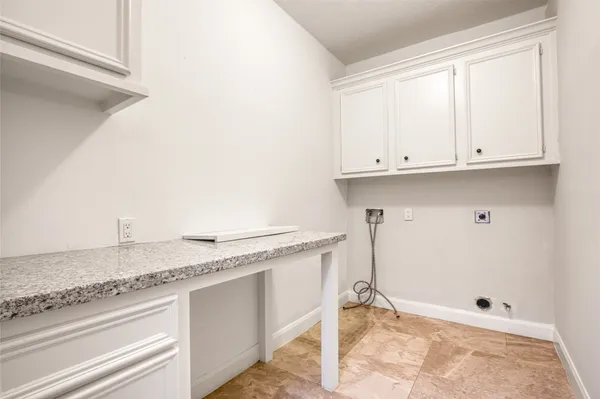 a view of kitchen with granite countertop white cabinets and white appliances