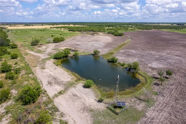 a view of a lake in front of house with a yard