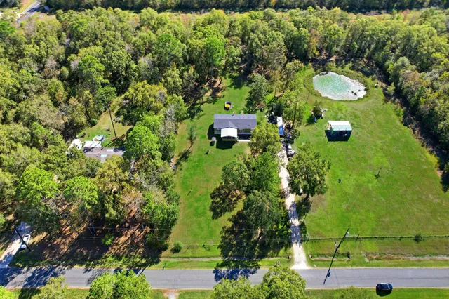 an aerial view of a house with yard swimming pool and outdoor seating