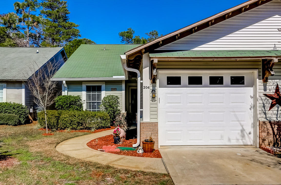 204 Vía Largo Santa Rosa Beach, FL 32459 - Photo 2 of 29 a front view of a house with garden