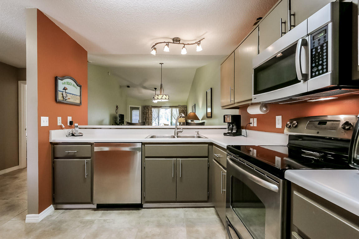 204 Vía Largo Santa Rosa Beach, FL 32459 - Photo 11 of 29 a kitchen with stainless steel appliances a stove microwave and sink