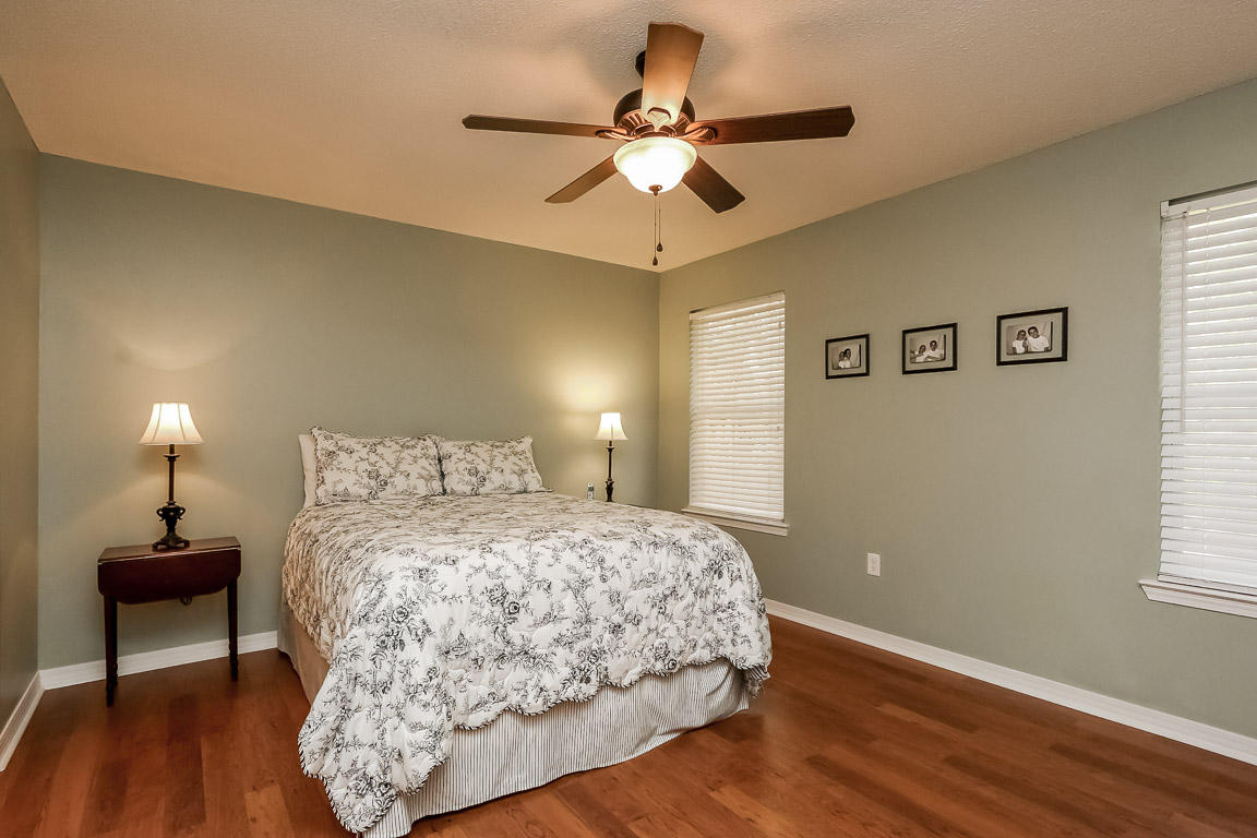 204 Vía Largo Santa Rosa Beach, FL 32459 - Photo 17 of 29 a bedroom with a bed and a chandelier