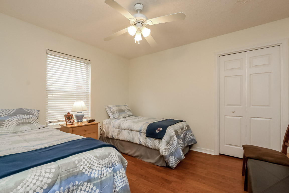 204 Vía Largo Santa Rosa Beach, FL 32459 - Photo 23 of 29 a bedroom with two beds and a chandelier