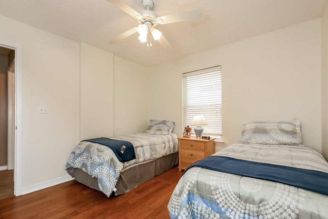 204 Vía Largo Santa Rosa Beach, FL 32459 - Photo 24 of 29 a bedroom with two beds and a chandelier