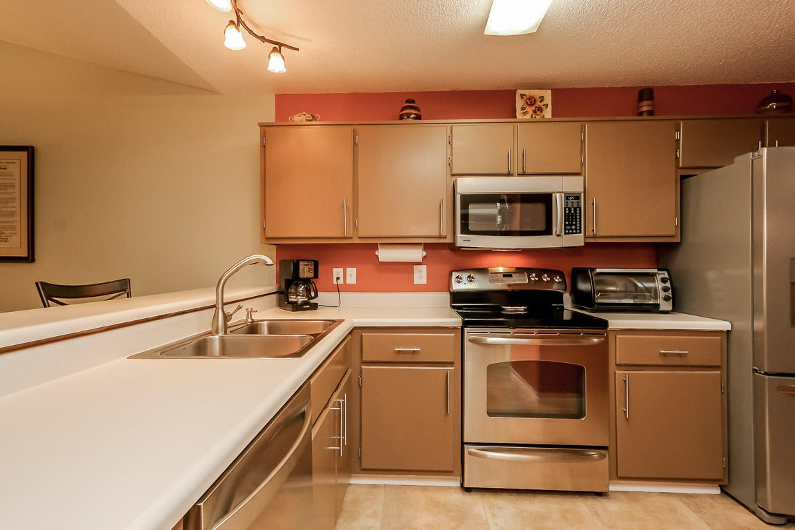 204 Vía Largo Santa Rosa Beach, FL 32459 - Photo 4 of 29 a kitchen with stainless steel appliances a stove a sink and a microwave