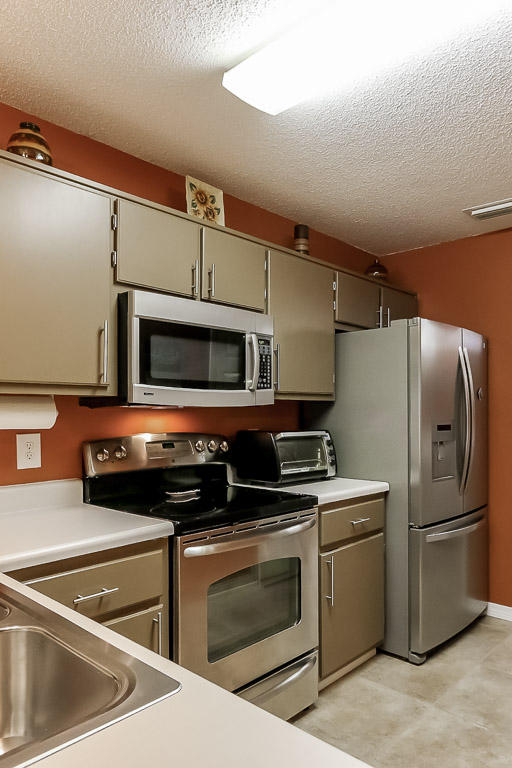 204 Vía Largo Santa Rosa Beach, FL 32459 - Photo 5 of 29 a kitchen with a stove microwave and refrigerator