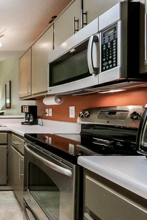 204 Vía Largo Santa Rosa Beach, FL 32459 - Photo 6 of 29 a kitchen with stainless steel appliances a stove and a microwave