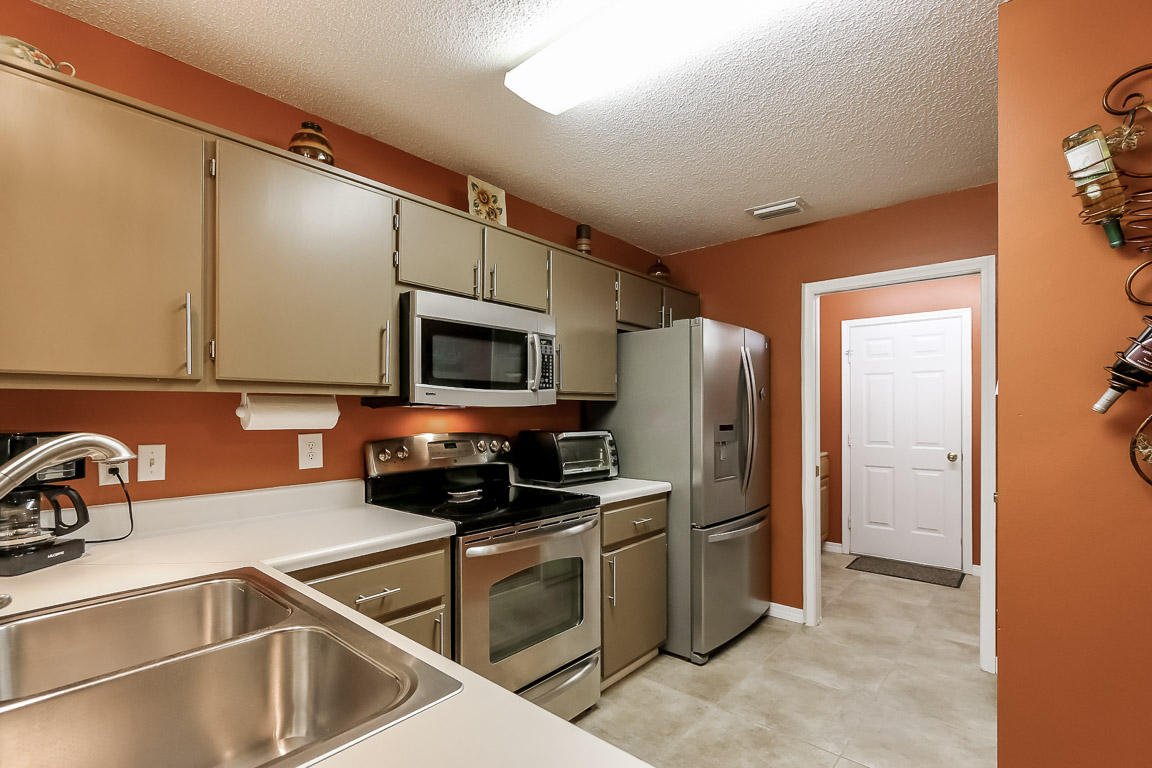 204 Vía Largo Santa Rosa Beach, FL 32459 - Photo 7 of 29 a kitchen with stainless steel appliances a refrigerator a sink a stove and cabinets