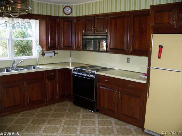 565 Broad St Road Manakin-Sabot, VA 23103 - Photo 2 of 8 a kitchen with stainless steel appliances granite countertop wooden cabinets a stove a sink and a window