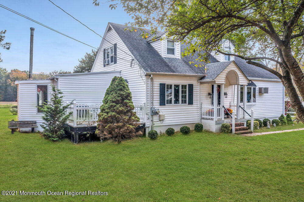 195 Bennett Road Freehold, NJ 07728 - Photo 4 of 90 a front view of a house with a garden and trees