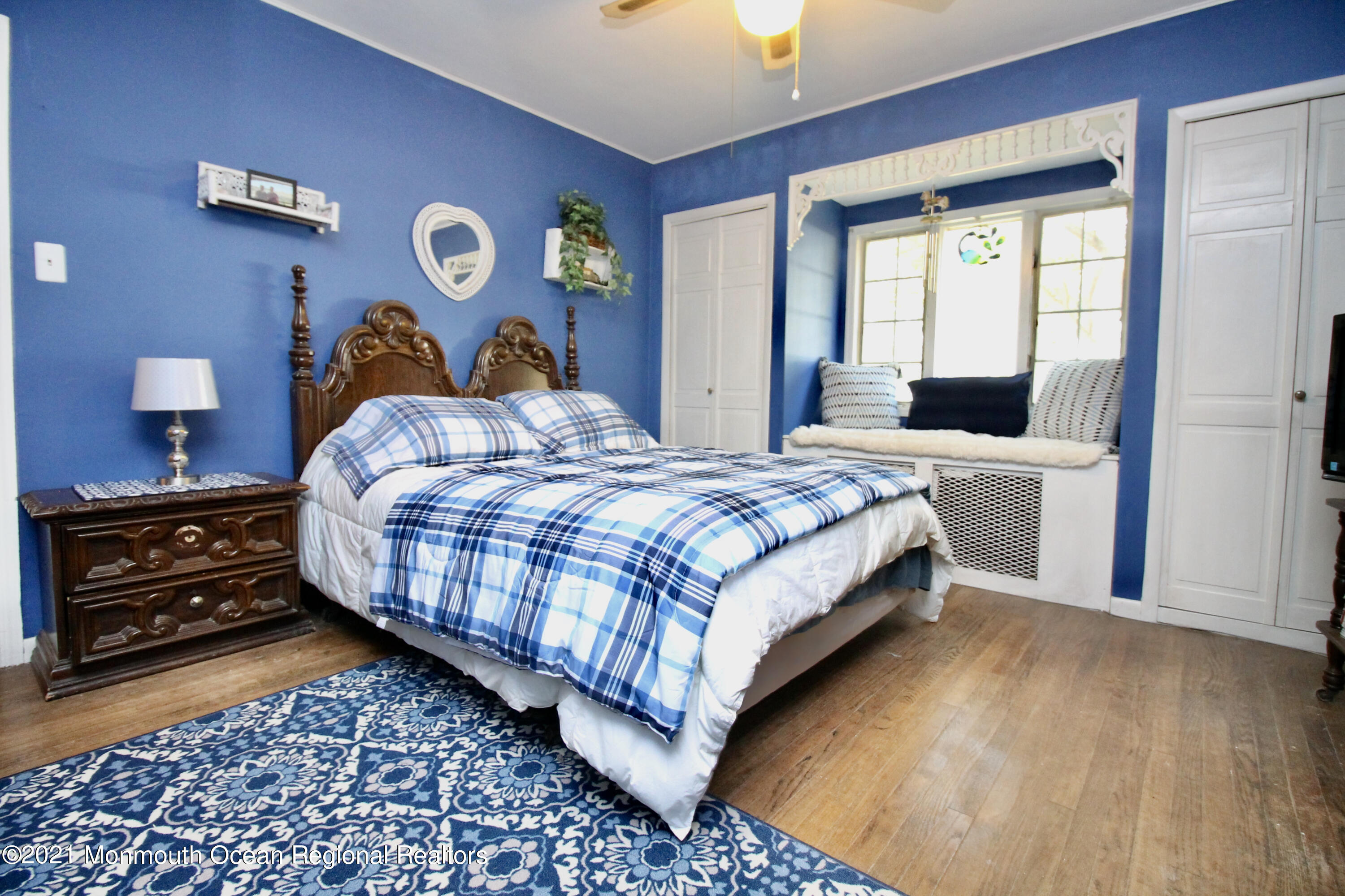 195 Bennett Road Freehold, NJ 07728 - Photo 33 of 90 a bedroom with a bed and a lamp on dresser with wooden floor