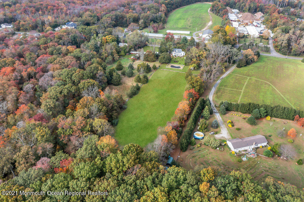195 Bennett Road Freehold, NJ 07728 - Photo 77 of 90 an aerial view of a house with a yard and lake view