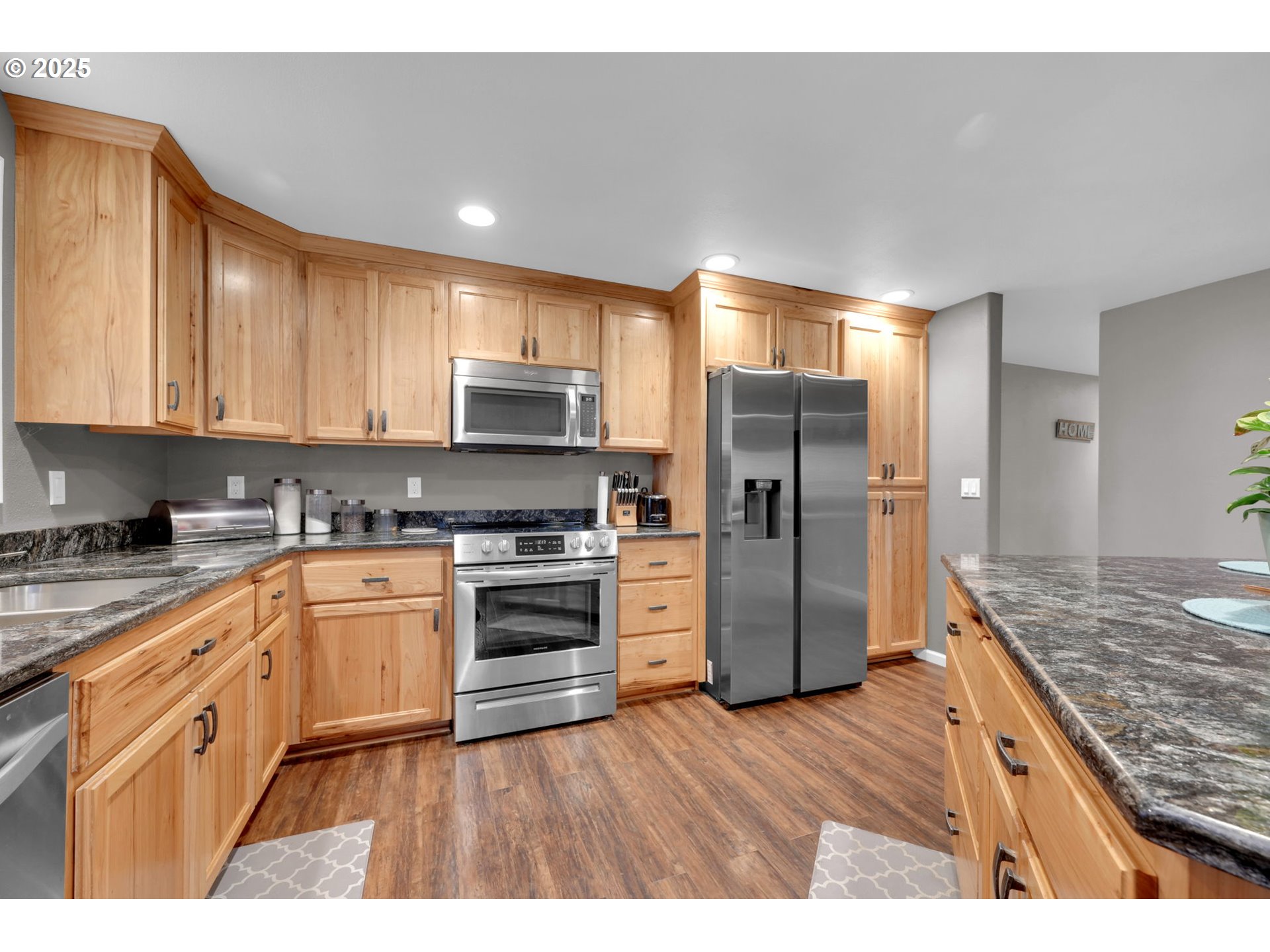 440 63rd Street Springfield, OR 97478 - Photo 13 of 39 a kitchen with stainless steel appliances granite countertop a refrigerator a stove and a sink