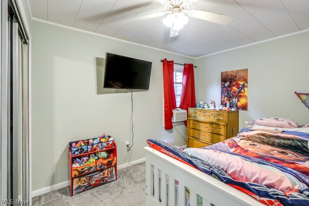 195 Canton Road Akron, OH 44312 - Photo 23 of 29 Carpeted bedroom with ornamental molding, a closet, and ceiling fan