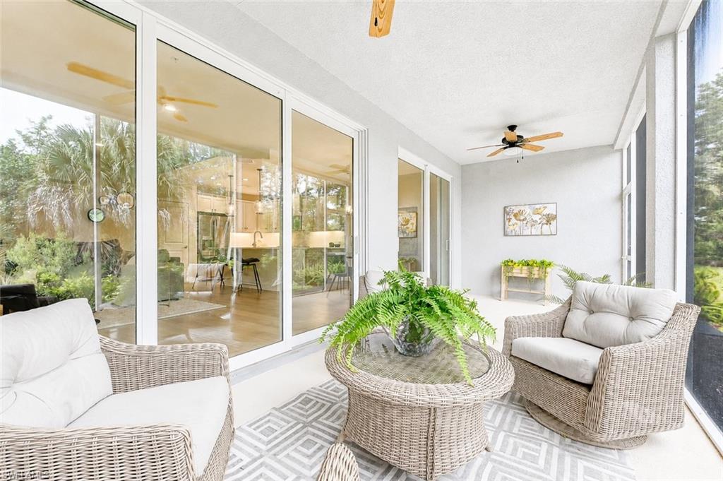 2620 Seychelles Circle, Unit 1302 Naples, FL 34112 - Photo 21 of 43 a living room with furniture and a large window