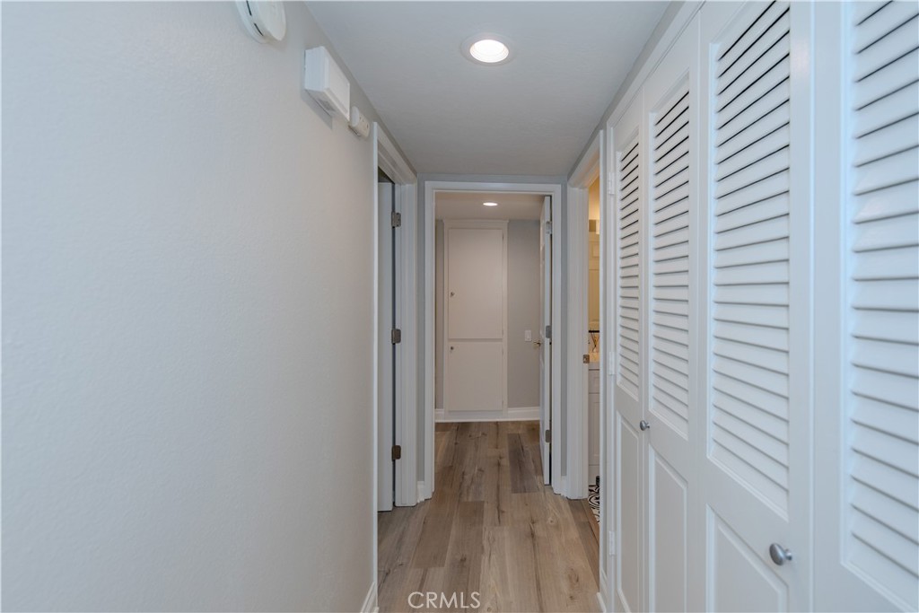 3379 Punta Alta, Unit B Laguna Woods, CA 92637 - Photo 11 of 25 a view of a hallway with wooden floor