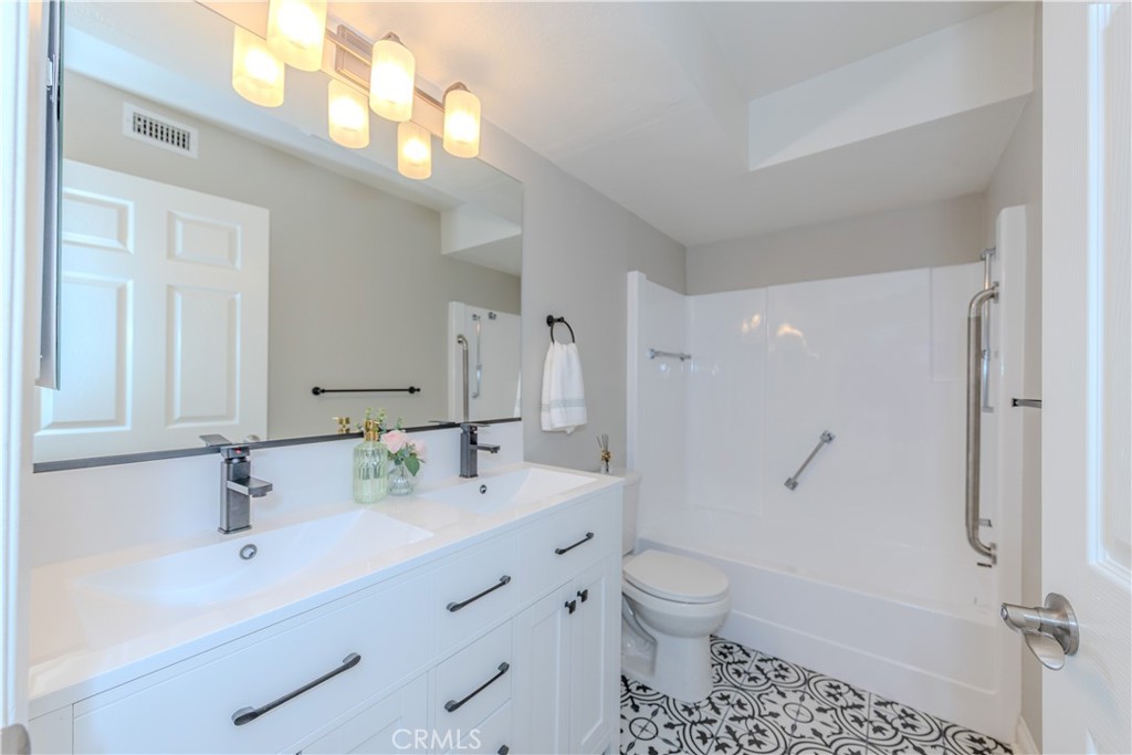 3379 Punta Alta, Unit B Laguna Woods, CA 92637 - Photo 14 of 25 a bathroom with a sink a toilet and shower