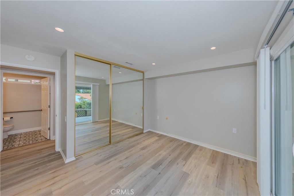 3379 Punta Alta, Unit B Laguna Woods, CA 92637 - Photo 17 of 25 an empty room with wooden floor