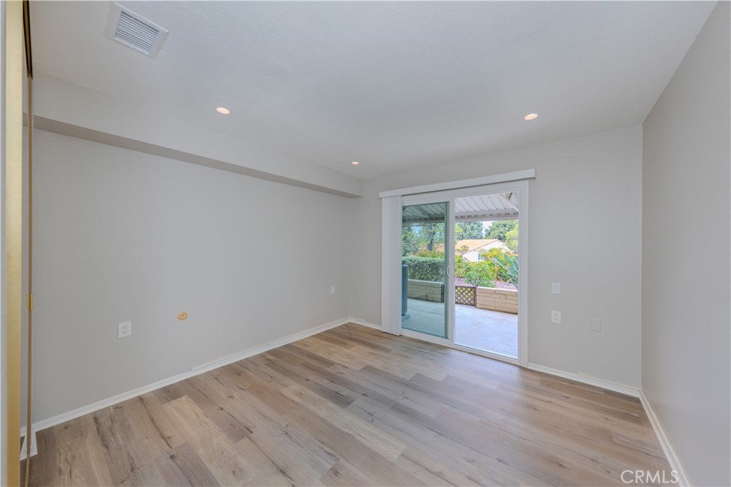 3379 Punta Alta, Unit B Laguna Woods, CA 92637 - Photo 18 of 25 wooden floor in an empty room with a window