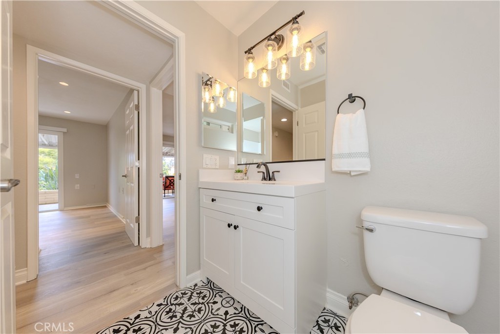 3379 Punta Alta, Unit B Laguna Woods, CA 92637 - Photo 19 of 25 a bathroom with a sink a toilet and a mirror