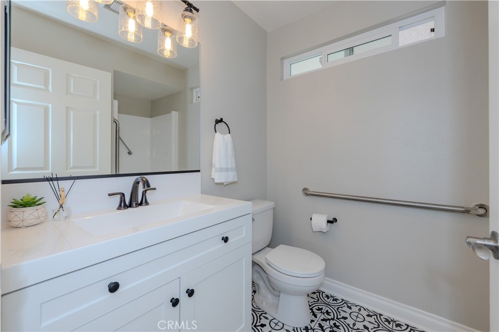 3379 Punta Alta, Unit B Laguna Woods, CA 92637 - Photo 20 of 25 a bathroom with a sink a toilet and mirror