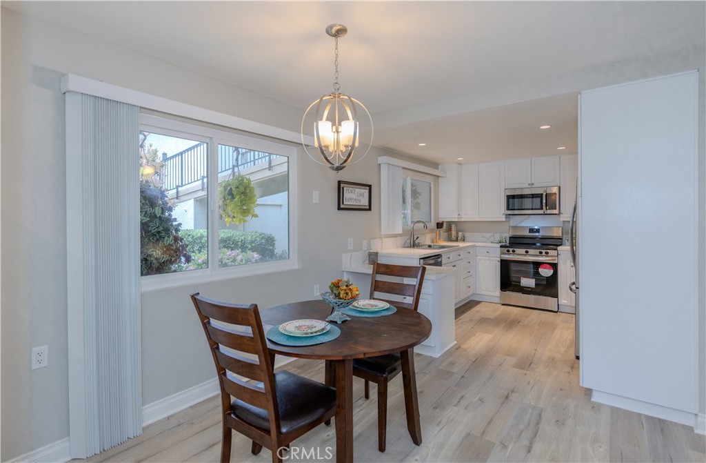 3379 Punta Alta, Unit B Laguna Woods, CA 92637 - Photo 4 of 25 a view of a dining room with furniture window and wooden floor