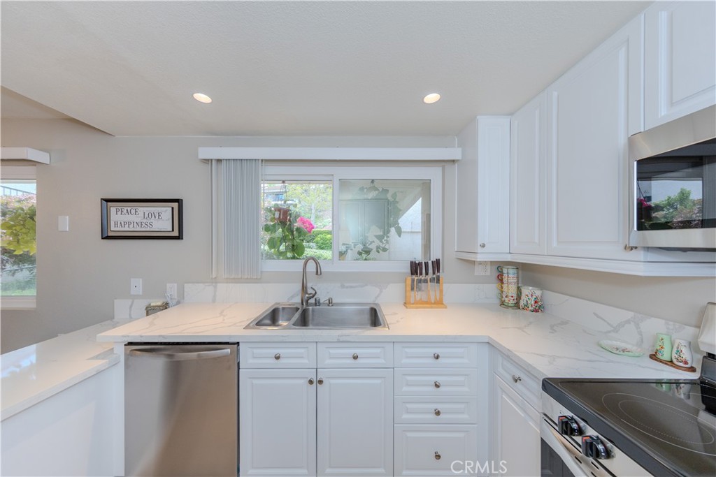 3379 Punta Alta, Unit B Laguna Woods, CA 92637 - Photo 6 of 25 a kitchen with sink and cabinets