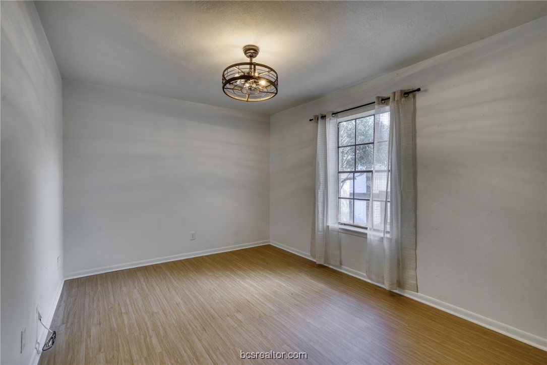2807 Sprucewood Street, Unit A Bryan, TX 77801 - Photo 9 of 13 Spare room featuring wood finished floors and a textured ceiling