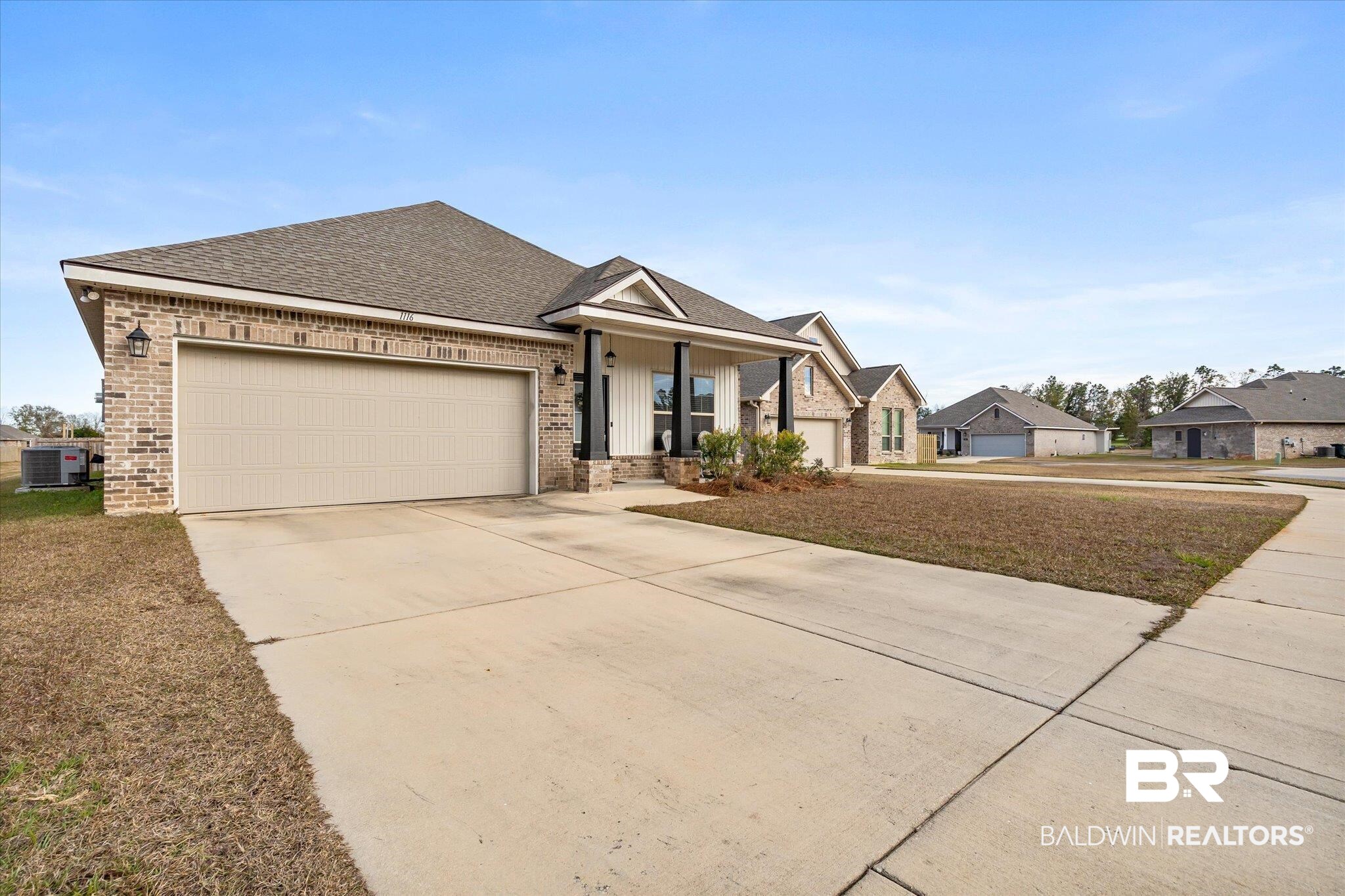 1116 Stella Road Foley, AL 36535 - Photo 29 of 29 View of front of property with a front yard, a garage, a porch, and cooling unit