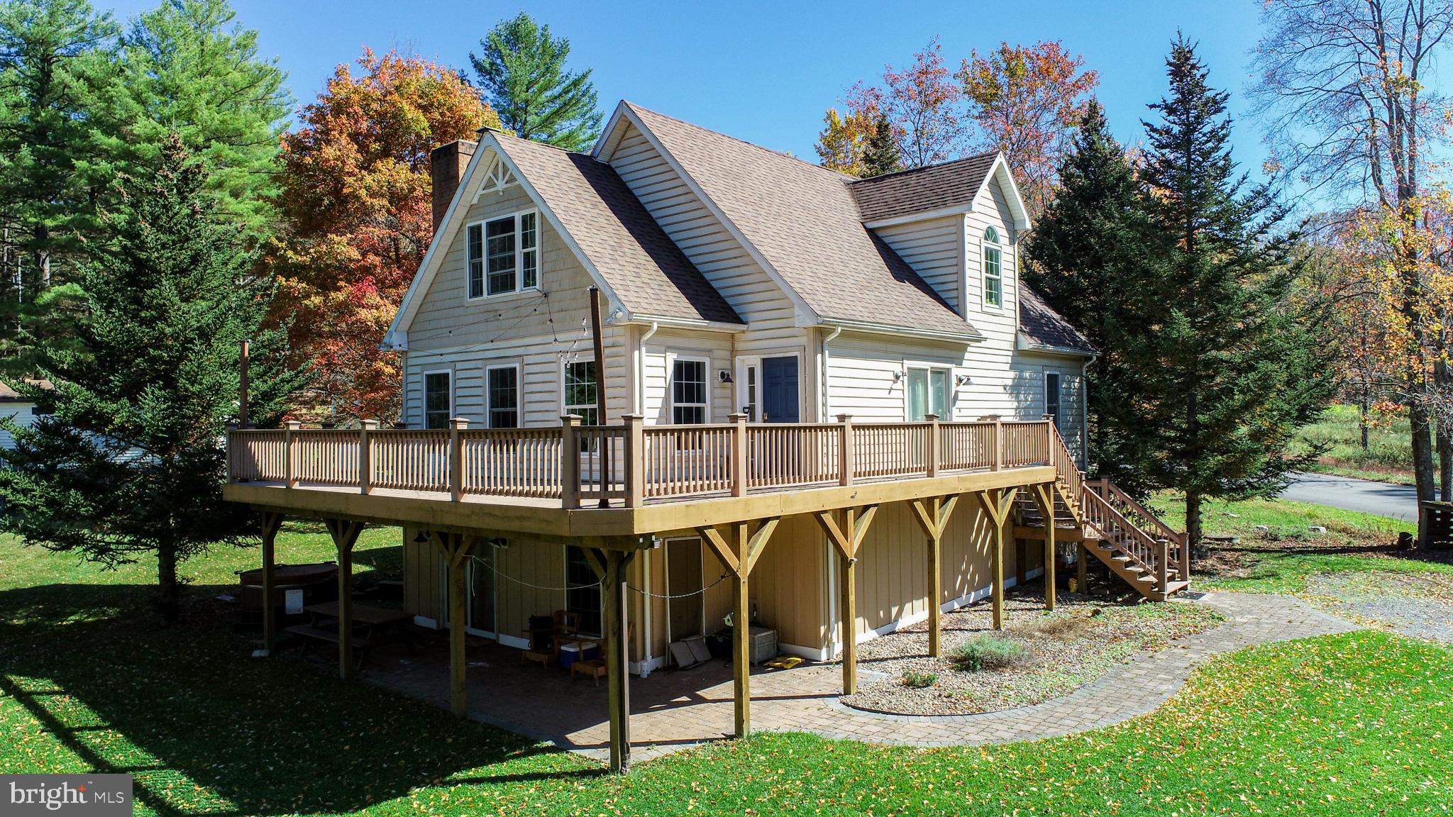 a view of a house with a yard porch and sitting area