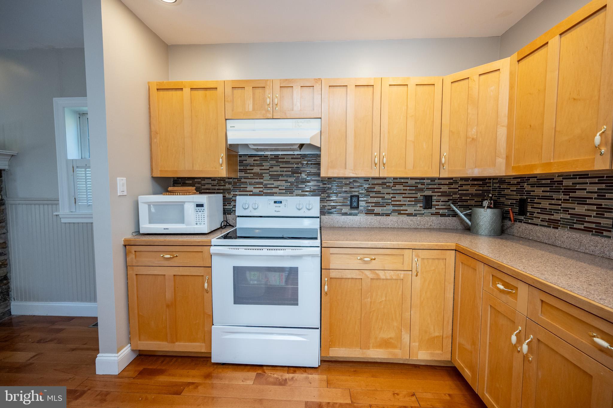 32 Hazelhurst Lane Swanton, MD 21561 - Photo 18 of 73 a kitchen with stainless steel appliances wooden cabinets and a stove top oven