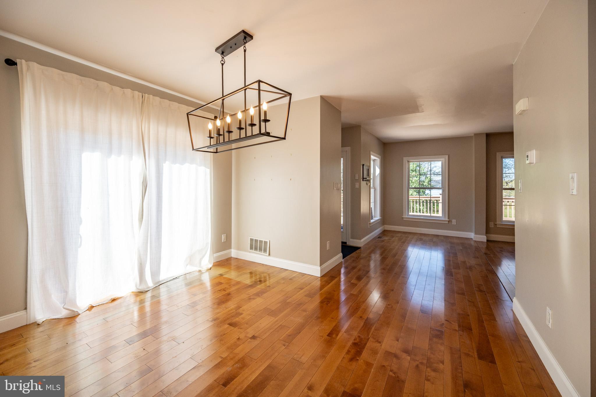 32 Hazelhurst Lane Swanton, MD 21561 - Photo 19 of 73 a view of a hallway with wooden floor and chandelier