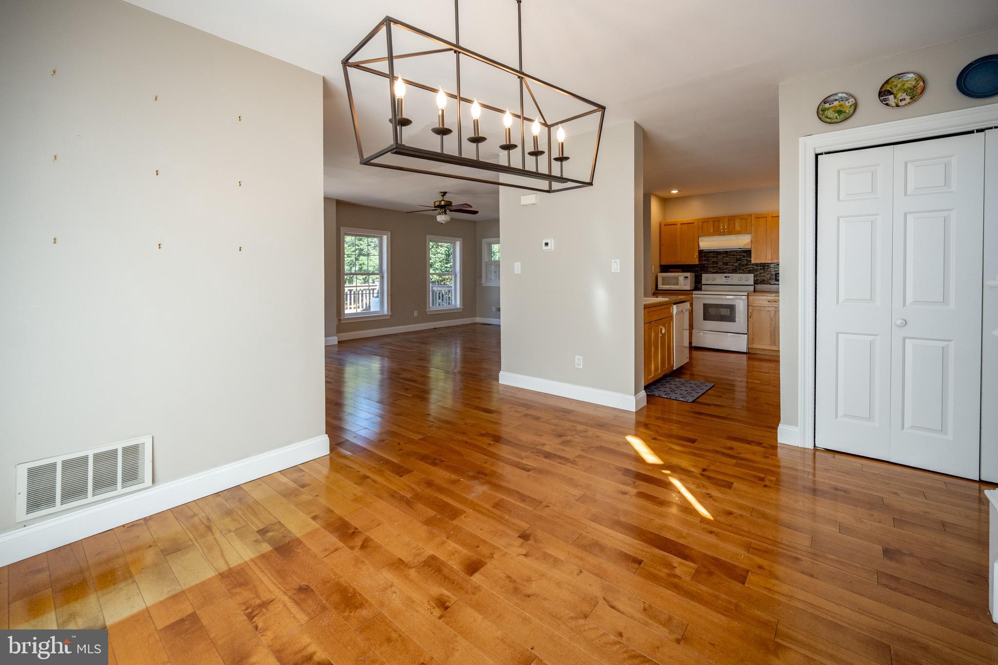 32 Hazelhurst Lane Swanton, MD 21561 - Photo 21 of 73 a view of a hallway with wooden floor and a kitchen