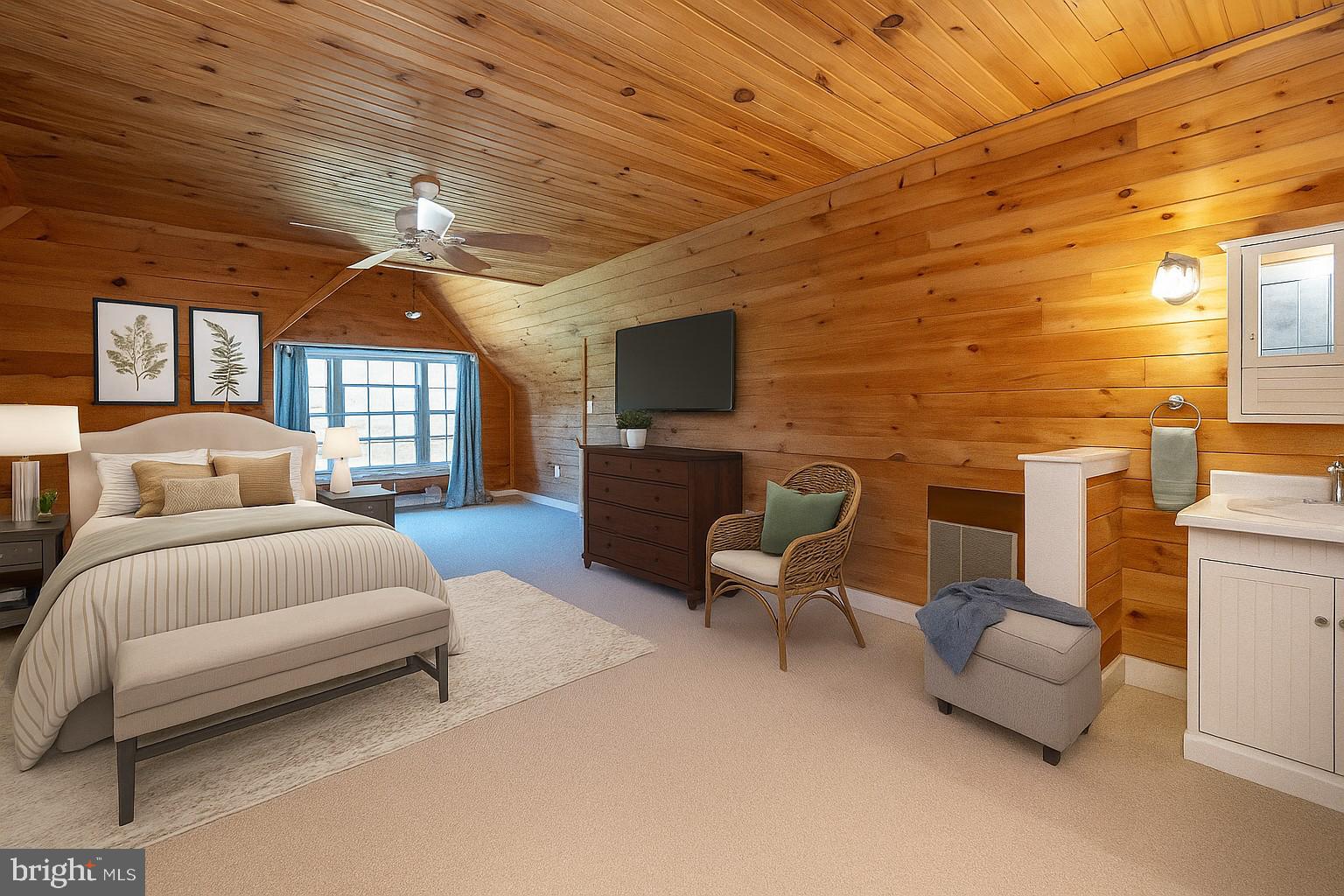 32 Hazelhurst Lane Swanton, MD 21561 - Photo 37 of 73 a spacious bedroom with a bed couch and a flat screen tv
