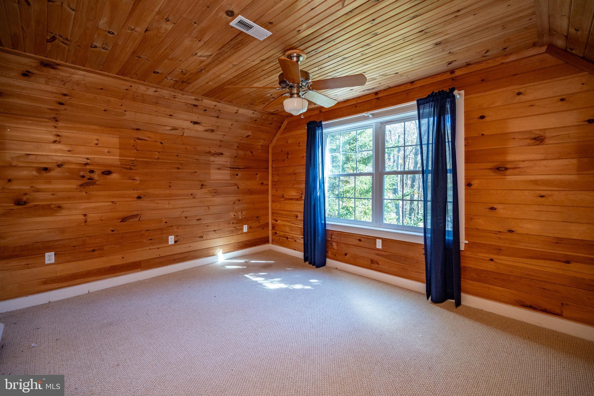32 Hazelhurst Lane Swanton, MD 21561 - Photo 42 of 73 a view of a room with wooden floor and a ceiling fan