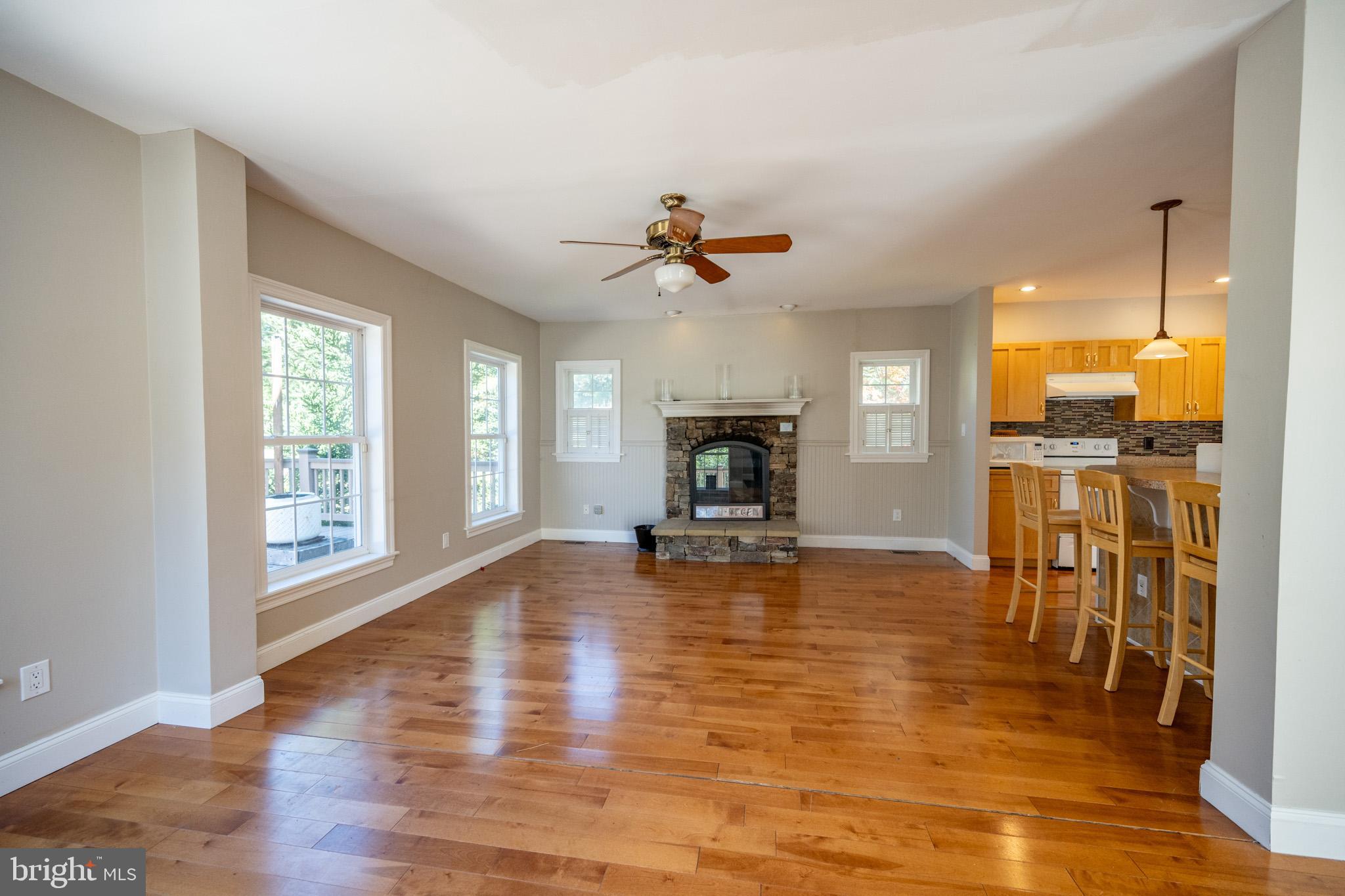 32 Hazelhurst Lane Swanton, MD 21561 - Photo 6 of 73 a view of a livingroom with furniture a fireplace wooden floor and a chandelier
