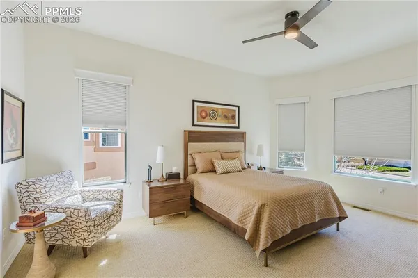 a bedroom with a bed and ceiling fan