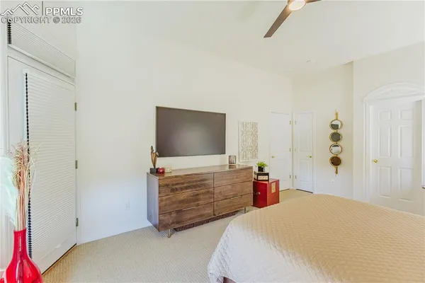 a bedroom with a bed and flat screen tv