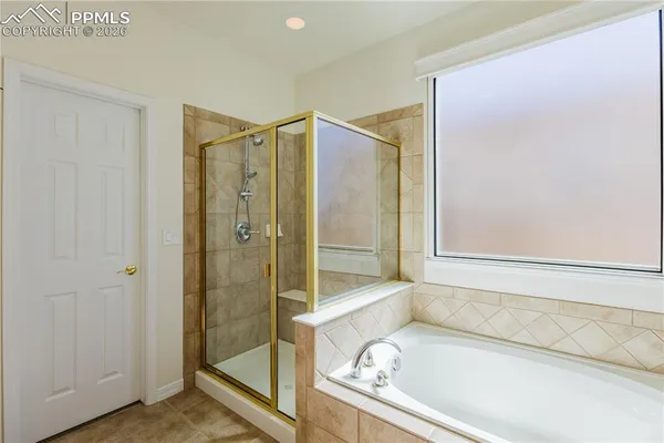 a bathroom with a tub and a shower
