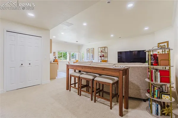 a dinning room with furniture and a flat screen tv