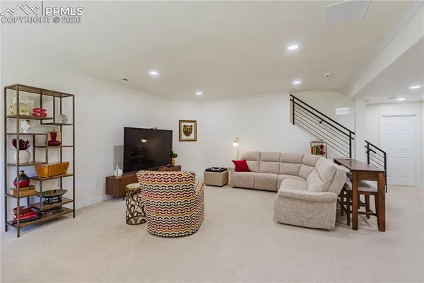 a bedroom with furniture and a book shelf