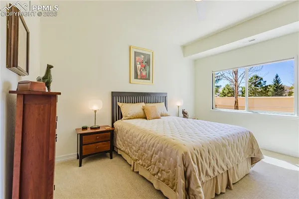 a bed sitting in a bedroom next to a window